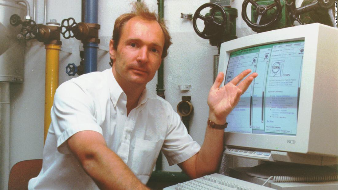 Sir Tim Berners-Lee poses in front of a series of tubes